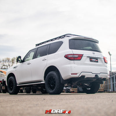 White SUV with roof rack on a paved surface, featuring 'MORE 4x4' branding.